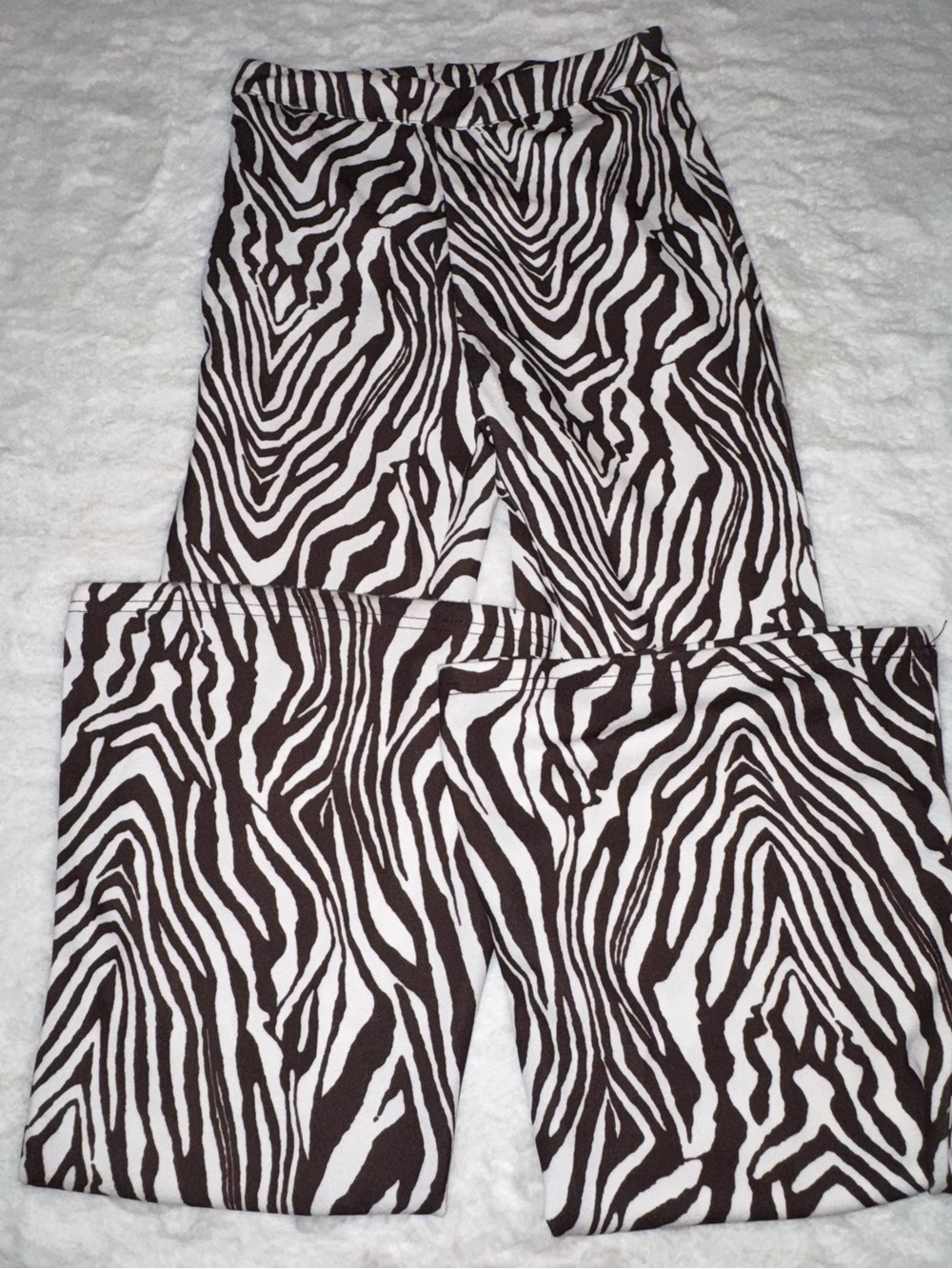 brown and white zebra print flare pants